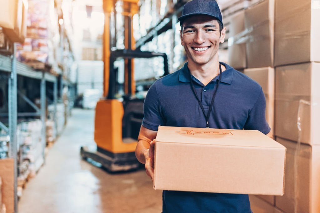 Boy holding a package in the warehouse